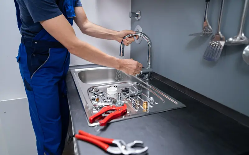 Plumber at a kitchen sink